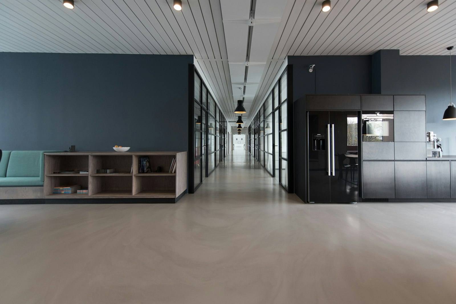 An empty modern office corridor with built-in cabinetry