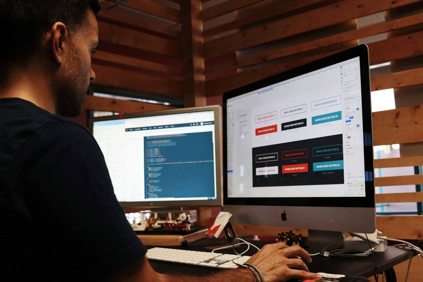 A person at a desktop computer editing a web page layout